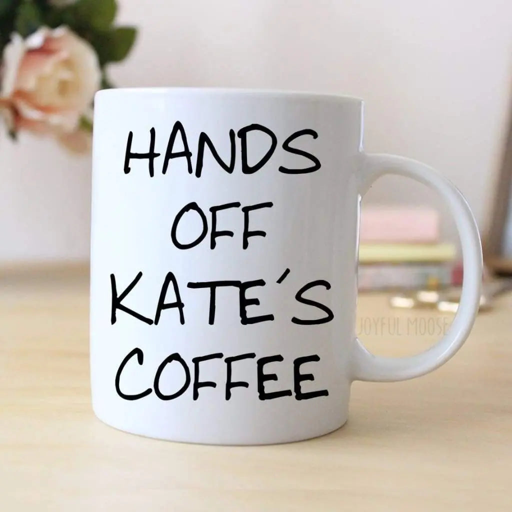 White coffee mug with black 'HANDS OFF KATE'S COFFEE' lettering