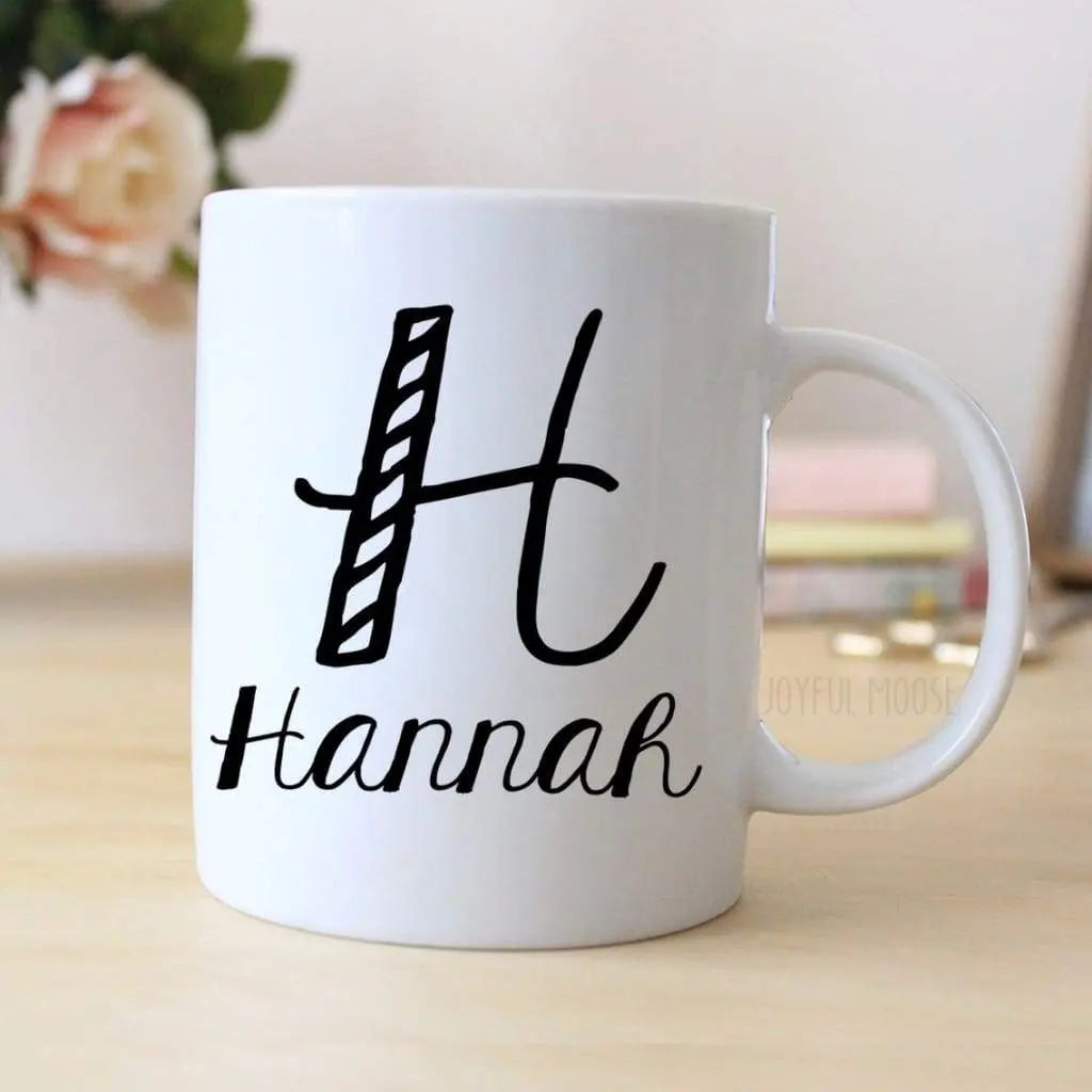 White ceramic mug with black 'hannah' name and monogram print