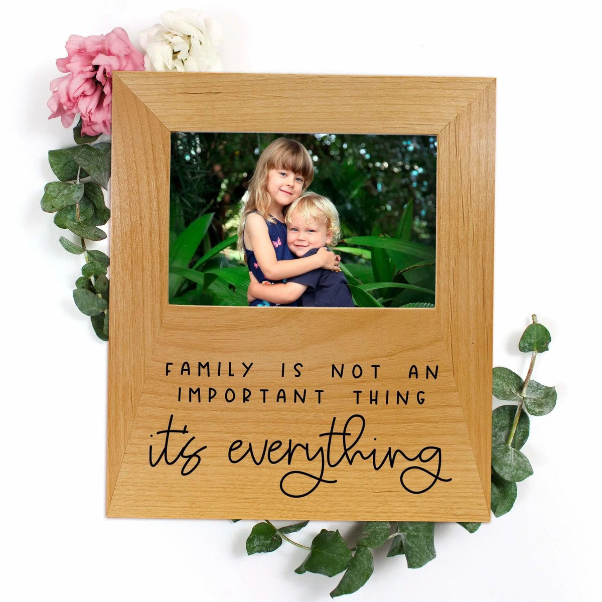 Natural wood photo frame with family quote text and rectangular photo opening