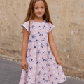 Pink girls cap-sleeve dress with blue butterfly pattern, gathered waist flare