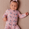 Pink bamboo zipper footie with butterfly and daisy print, front zip and long sleeves