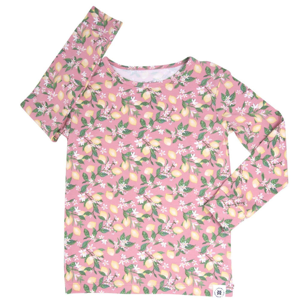 Kids pajama set with pink long-sleeve top and pants, lemon floral print, angled
