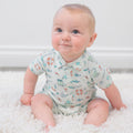 Baby fishing polo romper in light cream with teal and orange fishing-themed print