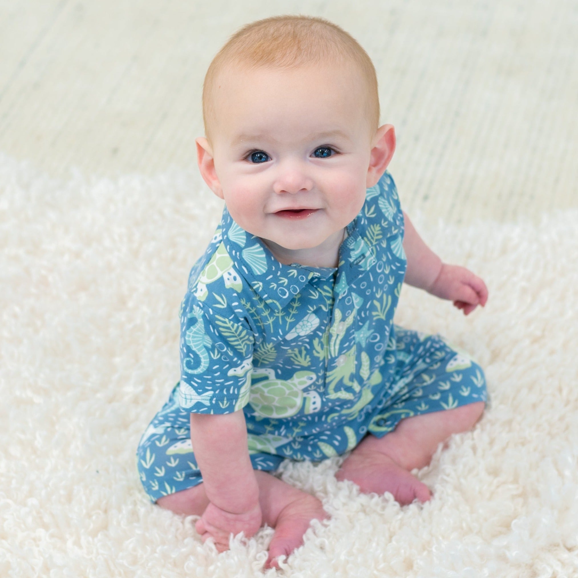 Boy polo romper in blue sea-life print, collar and short sleeves