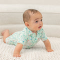 Turquoise polo romper for boy, short sleeves, button collar, tennis racket pattern.