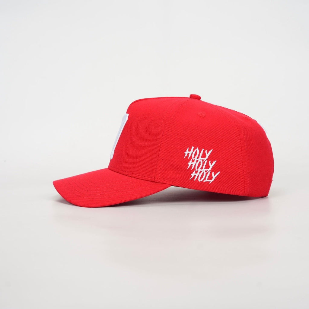 Red snapback cap with white hashtag-style side text and curved brim