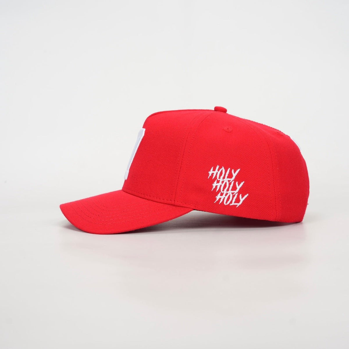 Red snapback cap with white hashtag-style side text and curved brim