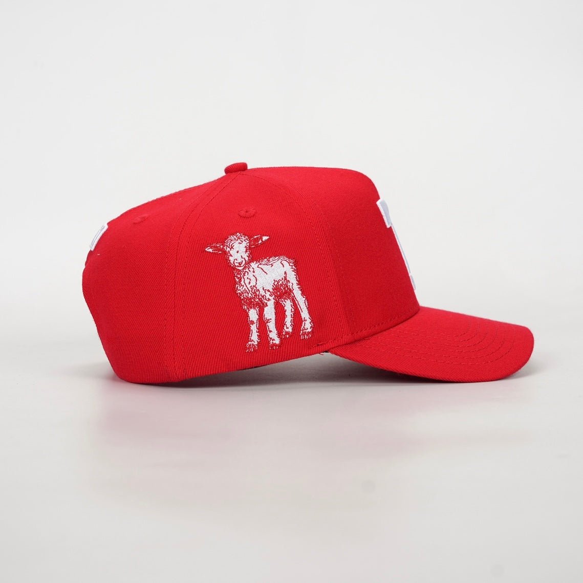 Red snapback cap with white animal graphic on the side