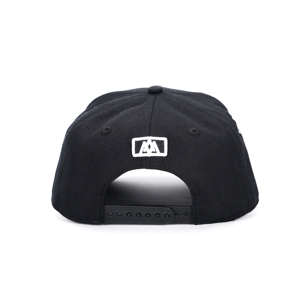 Black snapback cap with small square logo patch on front
