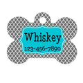Turquoise bone-shaped dog name tag with “Whiskey” and phone number 123-456-7890