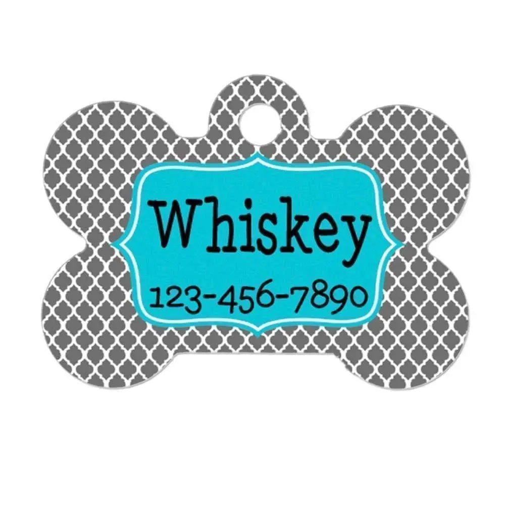 Turquoise bone-shaped dog name tag with “Whiskey” and phone number 123-456-7890