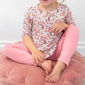 Girls tunic on model, short sleeves, crew neck; colorful unicorn and rainbow pattern