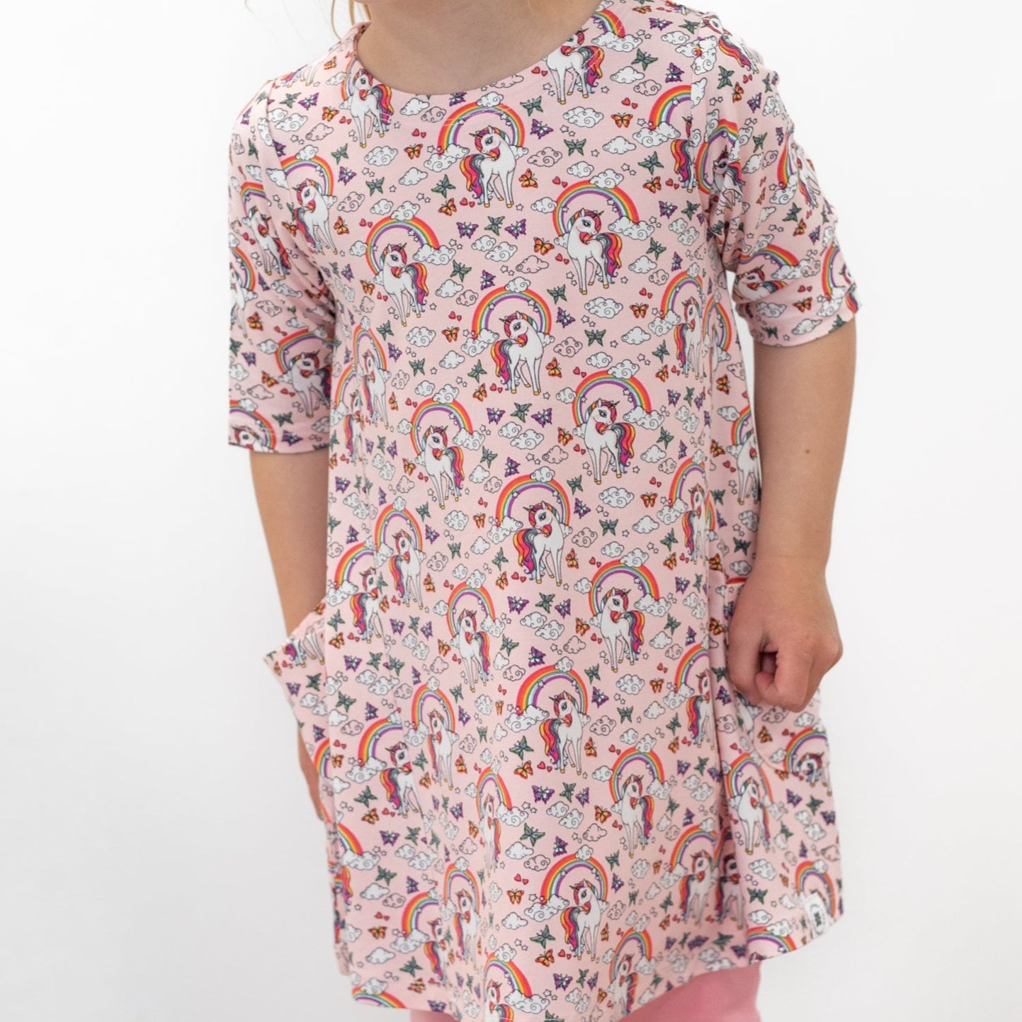 Girls short-sleeve tunic with crew neck and colorful unicorn/rainbow allover pattern
