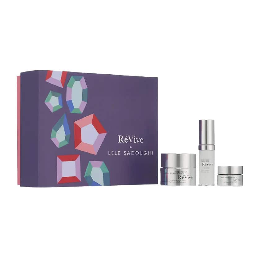 Skincare set with purple patterned gift box and multiple silver-capped bottles