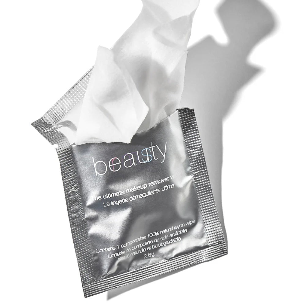 RMS Beauty makeup remover wipe emerging from silver foil pack
