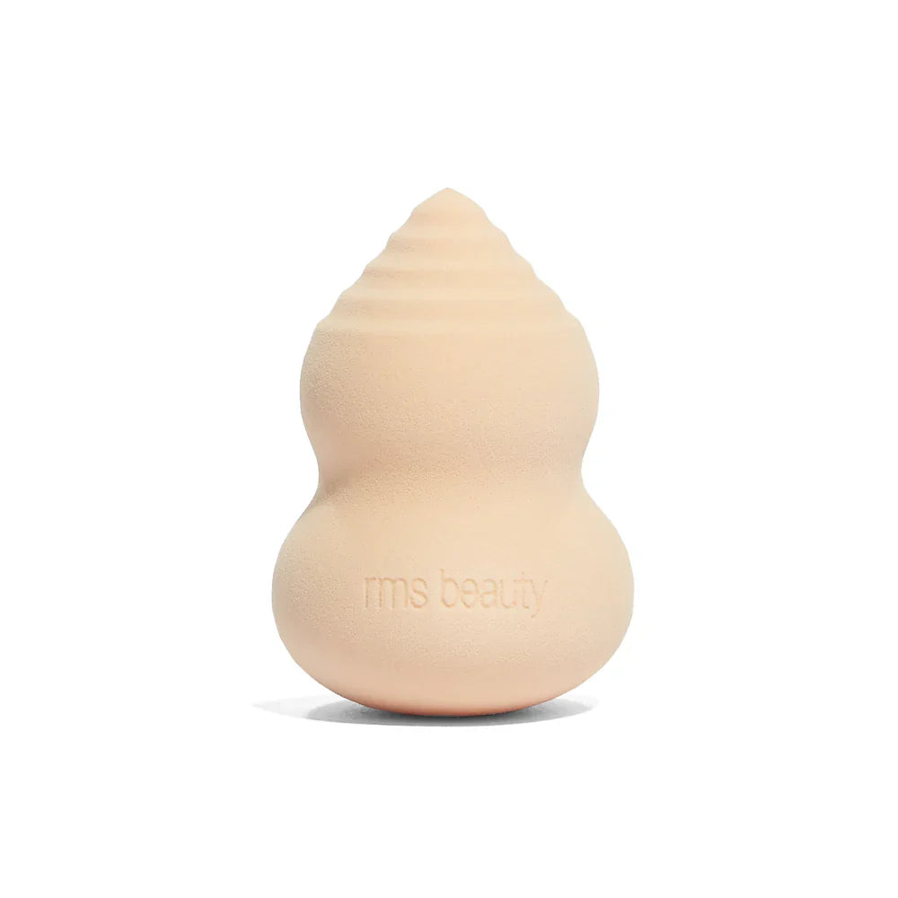 Beige beauty sponge with rounded teardrop shape, stamped rms beauty