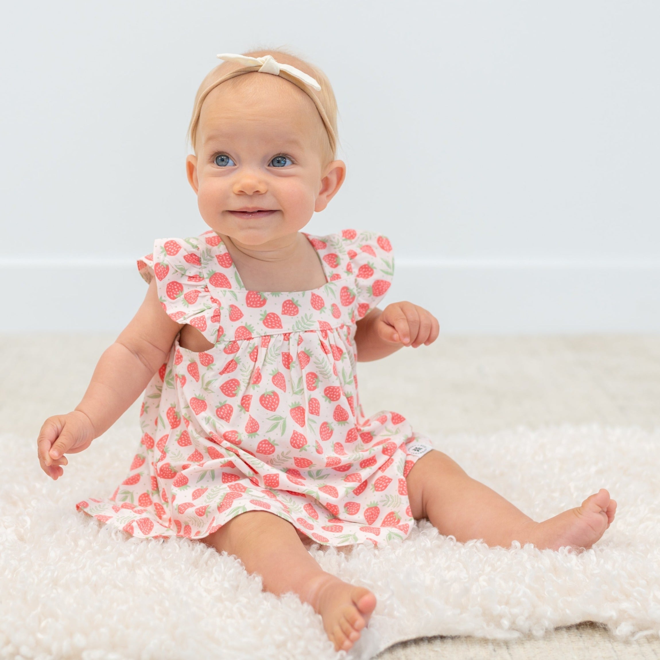 Girls ruffle dress in strawberry print with gathered waist and ruffled hem