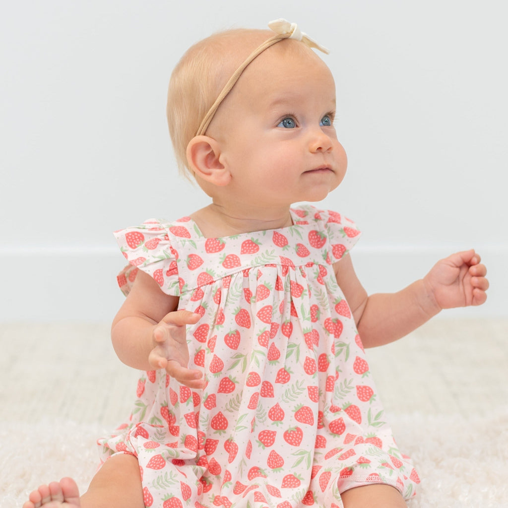 Girls ruffle dress in strawberry print with bow-like ruffled shoulders