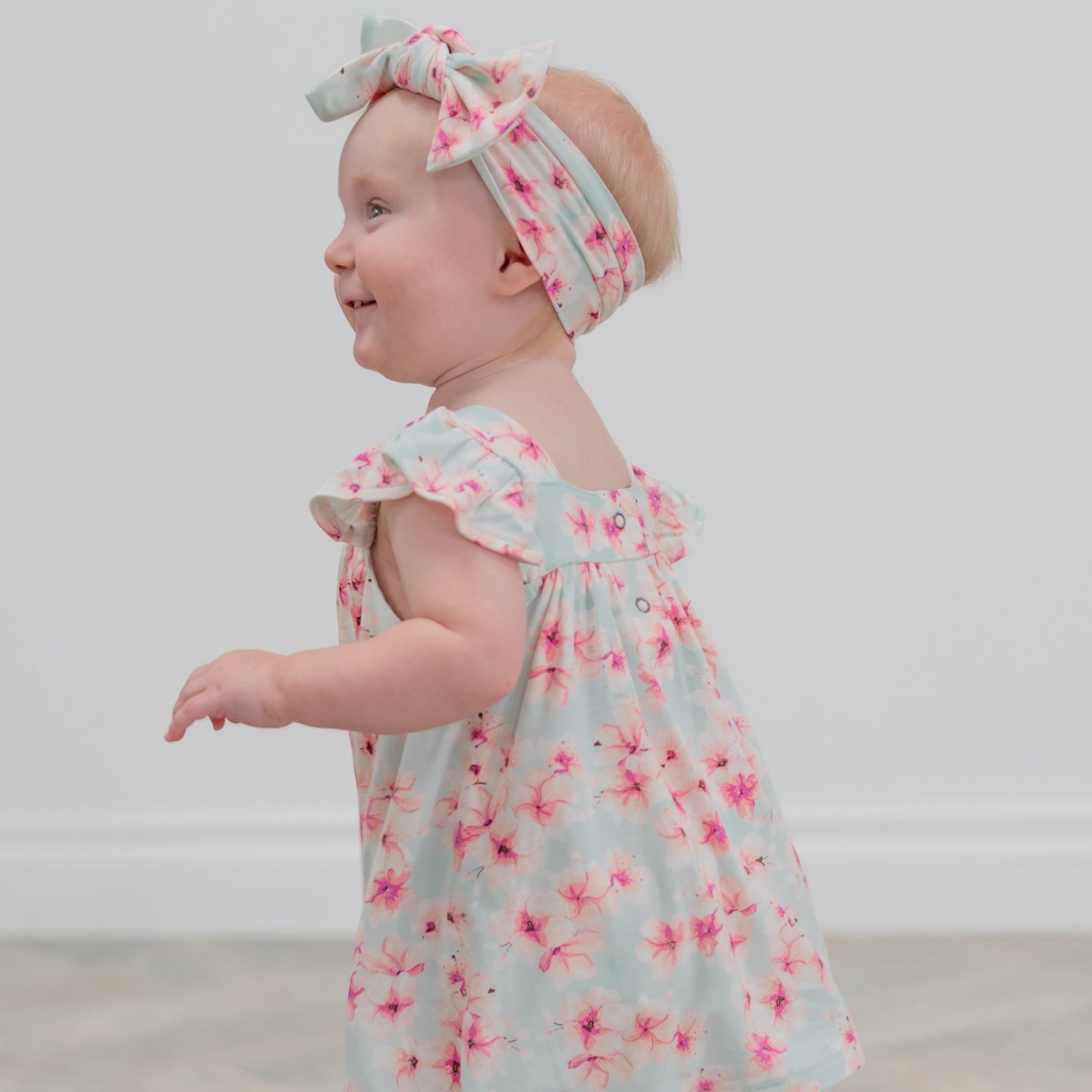 Light blue floral ruffle dress with pink flower print and layered shoulder ruffles