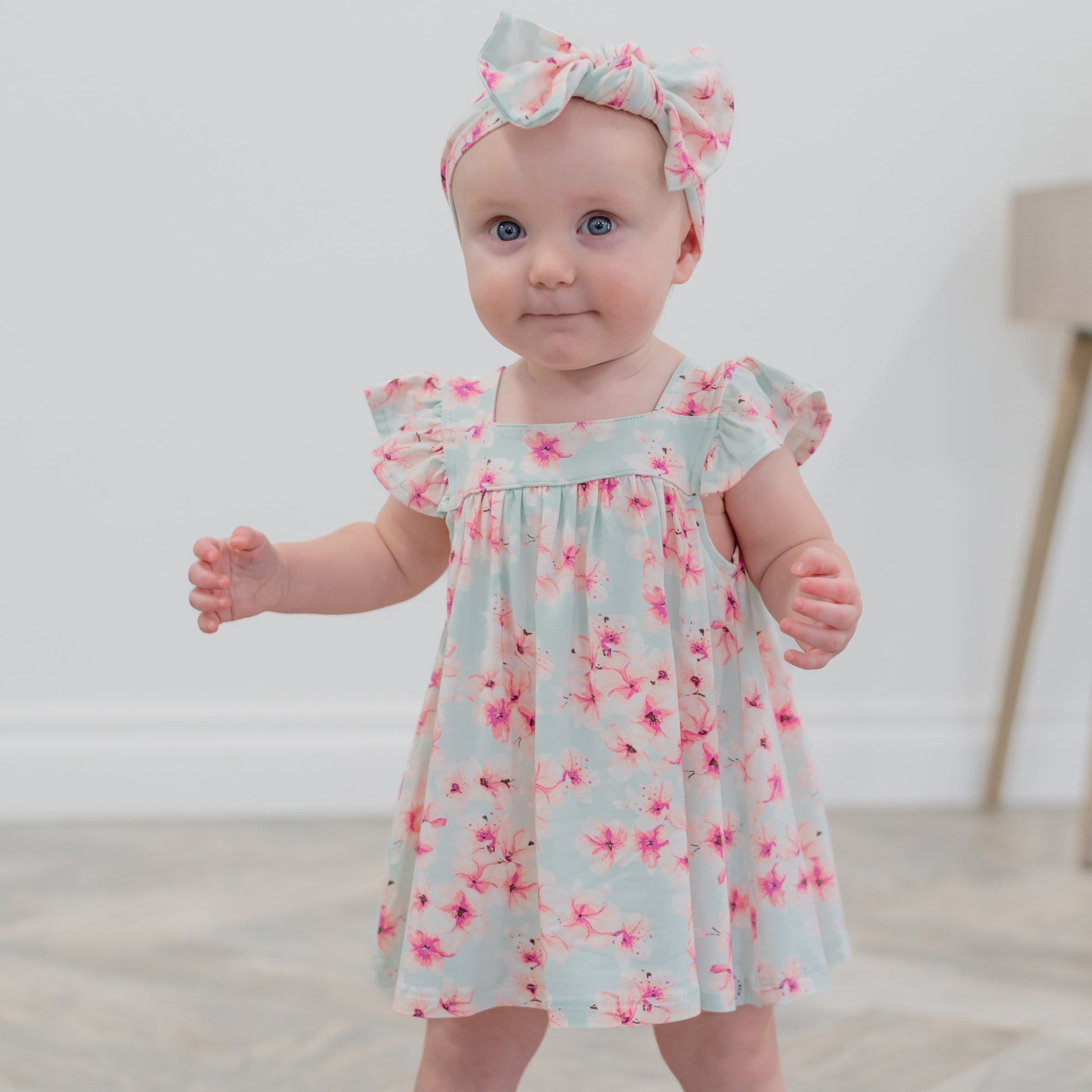 Light blue floral ruffle dress with pink flowers and bow-tie neckline