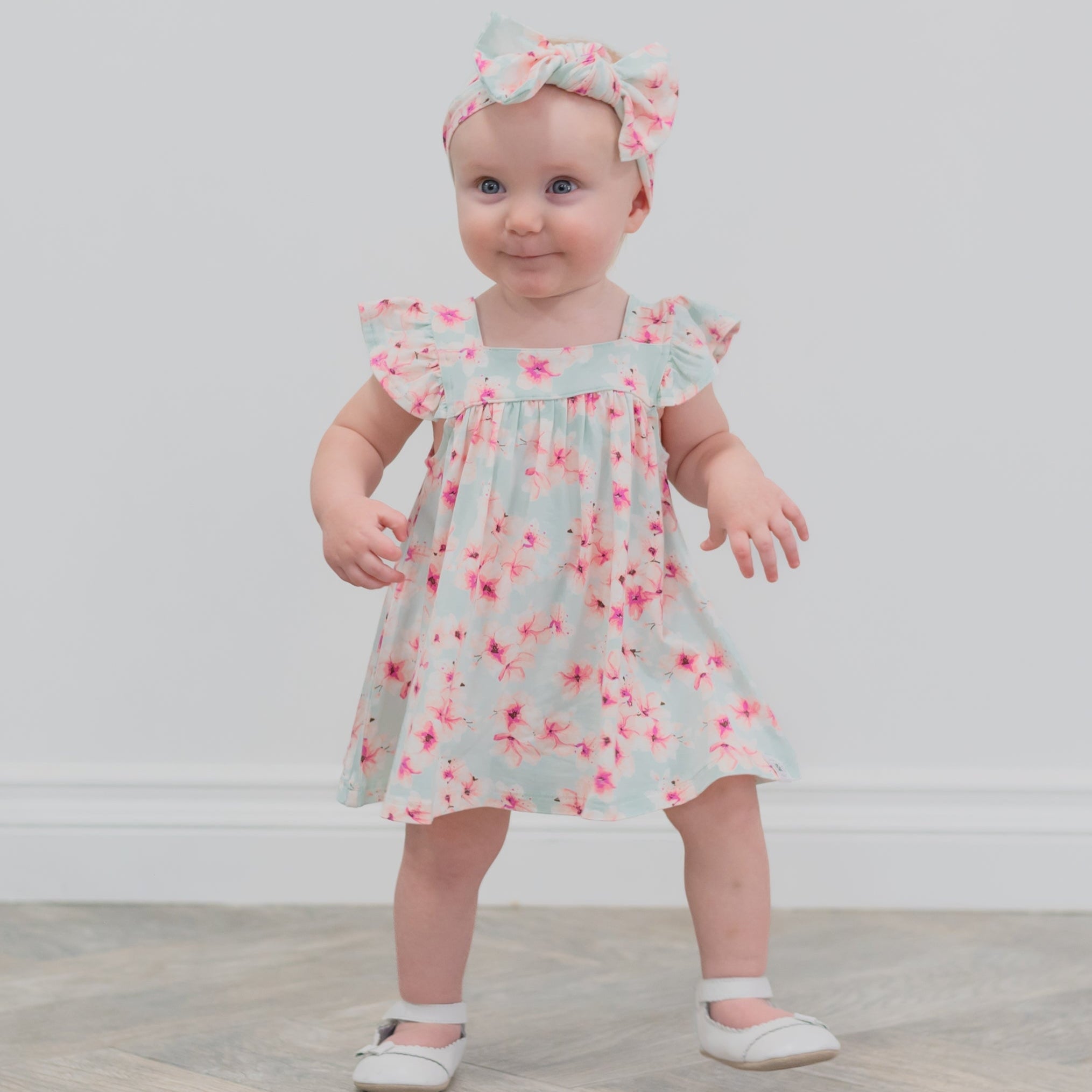 Light blue floral ruffle dress with pink flower print and flutter sleeves