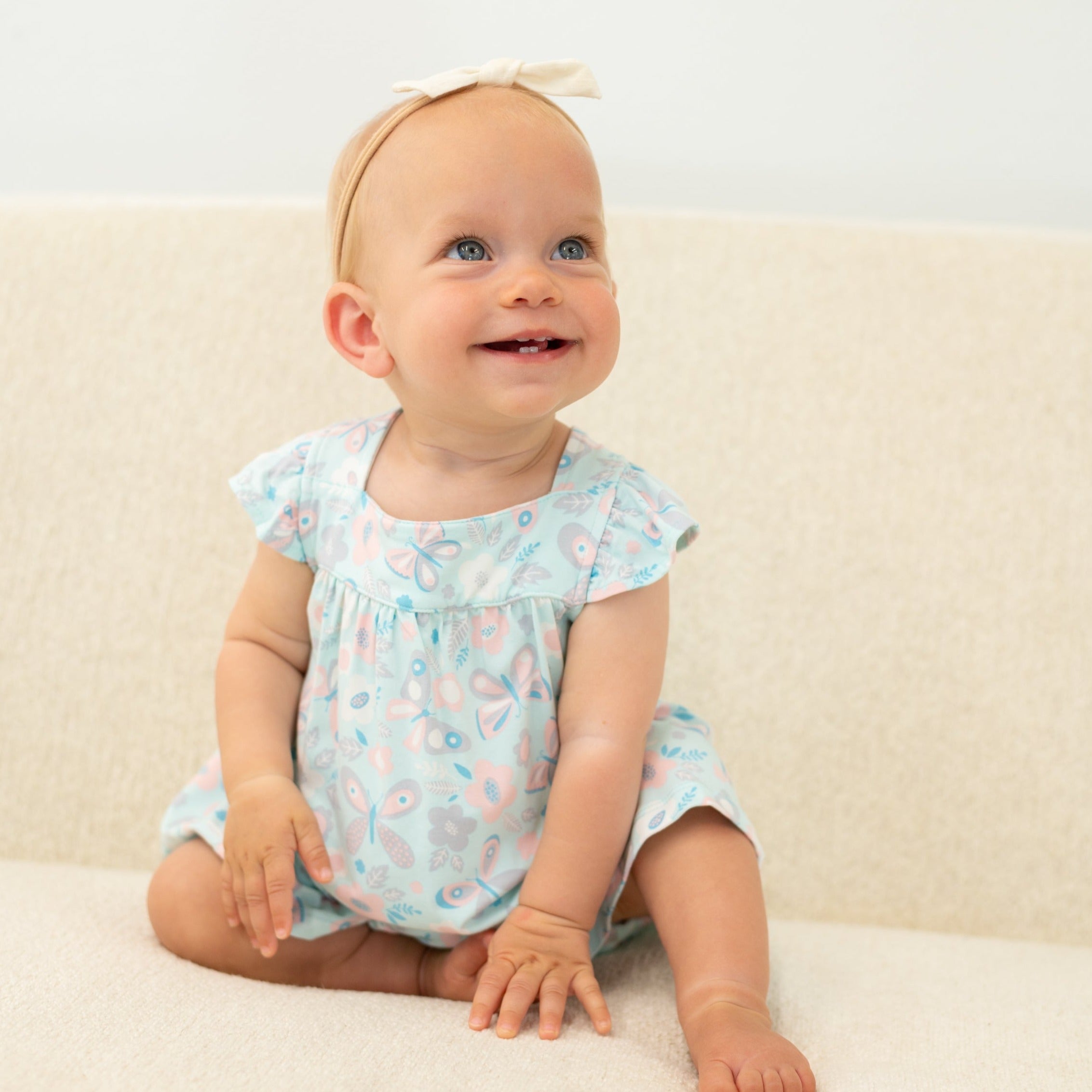 Ruffled aqua dress with matching bloomer shorts, flutter sleeves and butterfly print