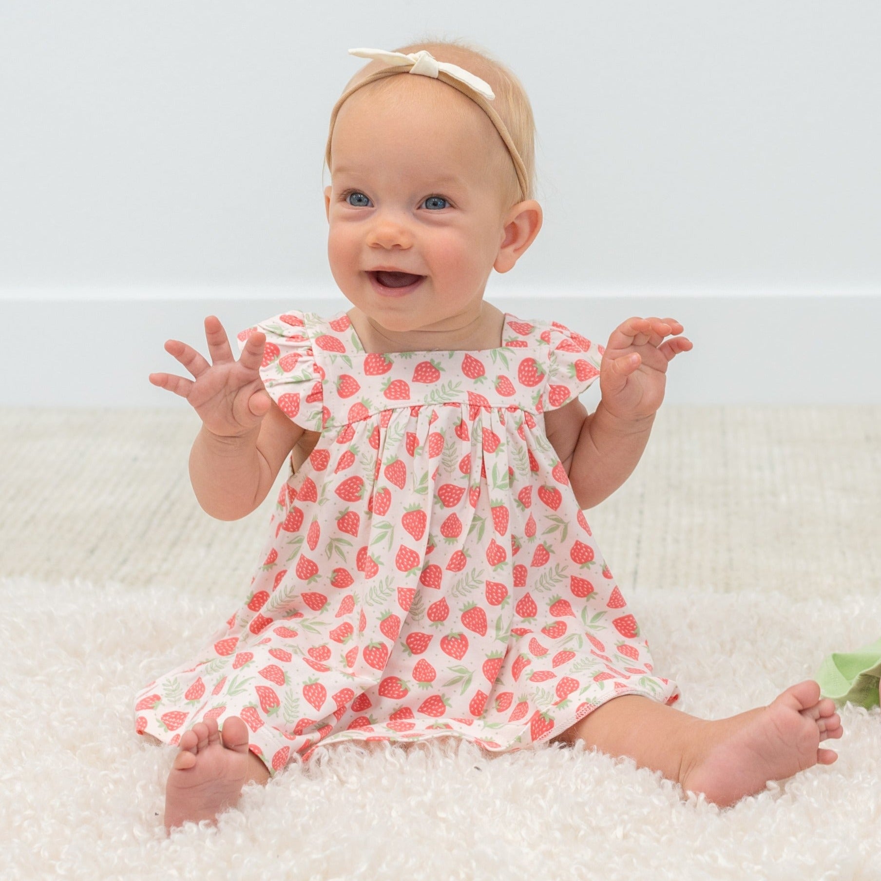 Girls ruffle dress with strawberry print, flutter sleeves and gathered neckline