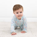 Baby ruffle footie with zip front, light blue floral-and-bird print
