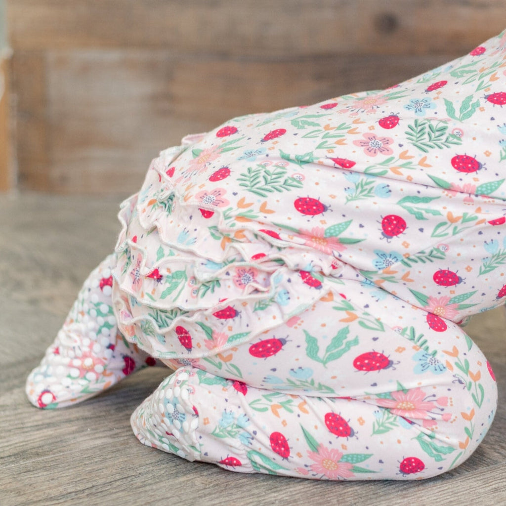 Folded baby footie pajamas with floral ladybug print and zip front, long sleeves