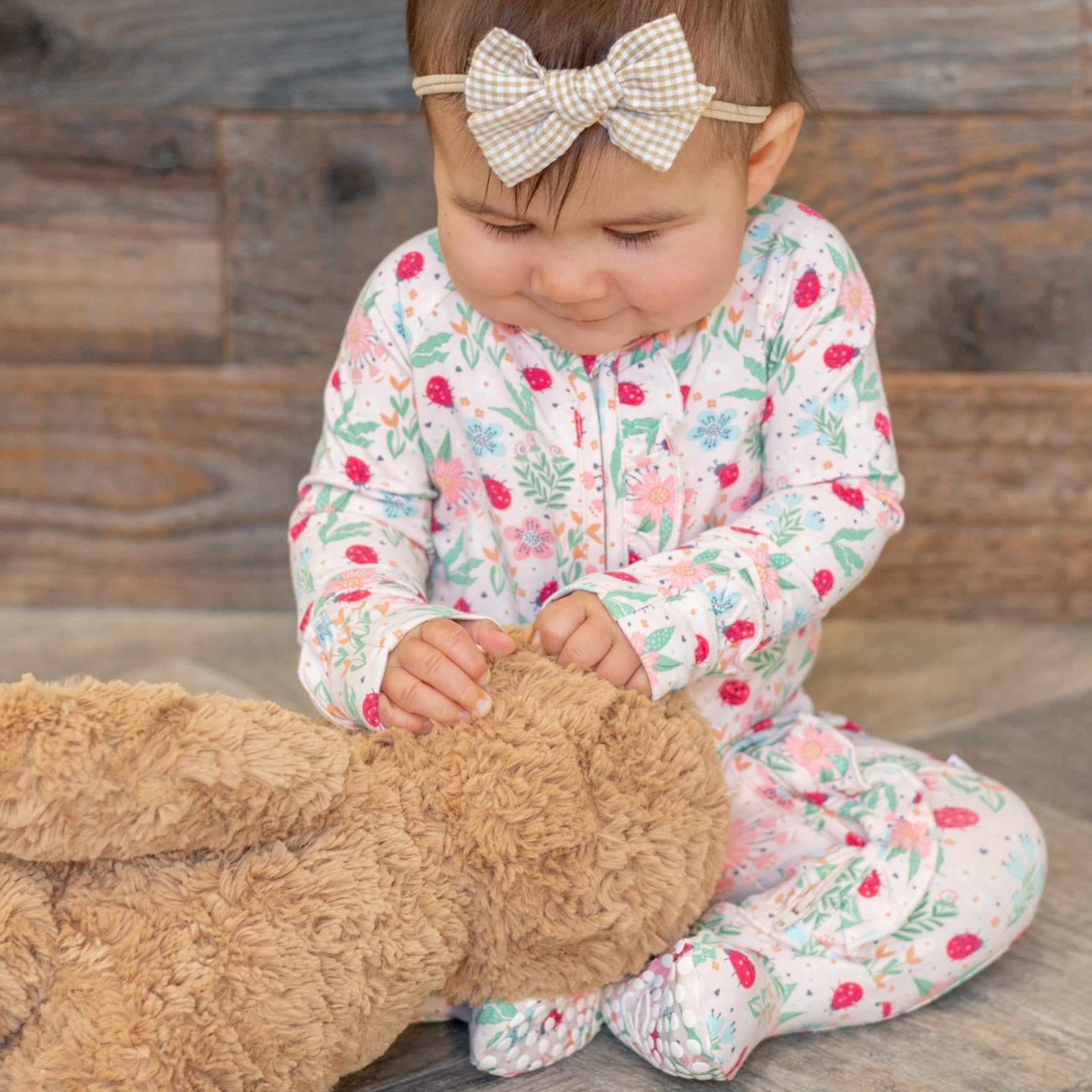 Baby footie pajamas with ruffle collar and floral ladybug print, long sleeves, zip front