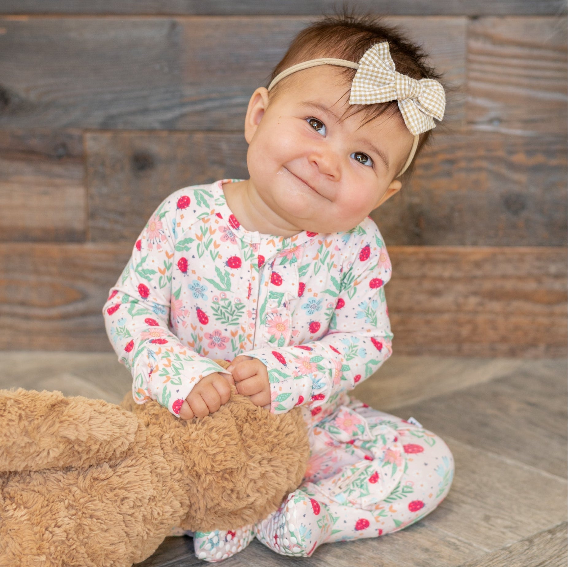 Baby footie pajamas in floral ladybug print with ruffle collar and zip front