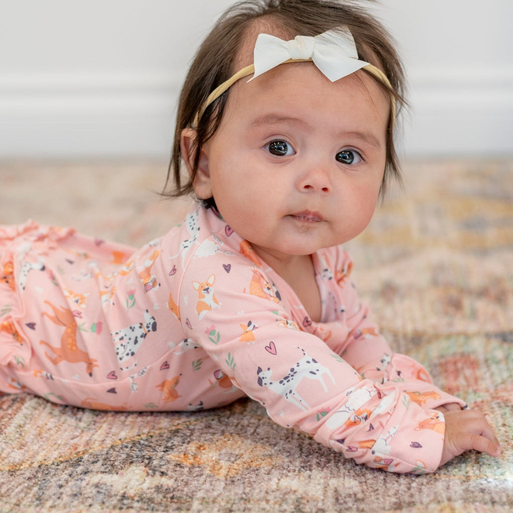 Pink long-sleeve animal-print footie with soft ruffle neckline