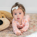 Pink ruffle footie with cute animal print and snap front