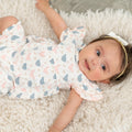 Baby girl romper in pastel bird print with ruffled sleeves and short legs