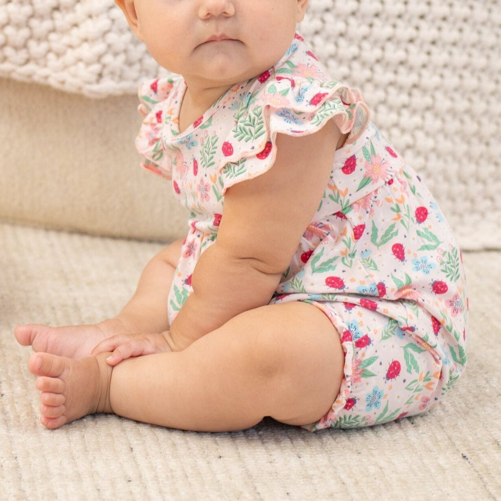 Baby ruffle romper with ladybug and floral print, pink trim, short flutter sleeves