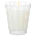 Nest New York bamboo candle in clear ribbed glass with lit flame and NEST logo.