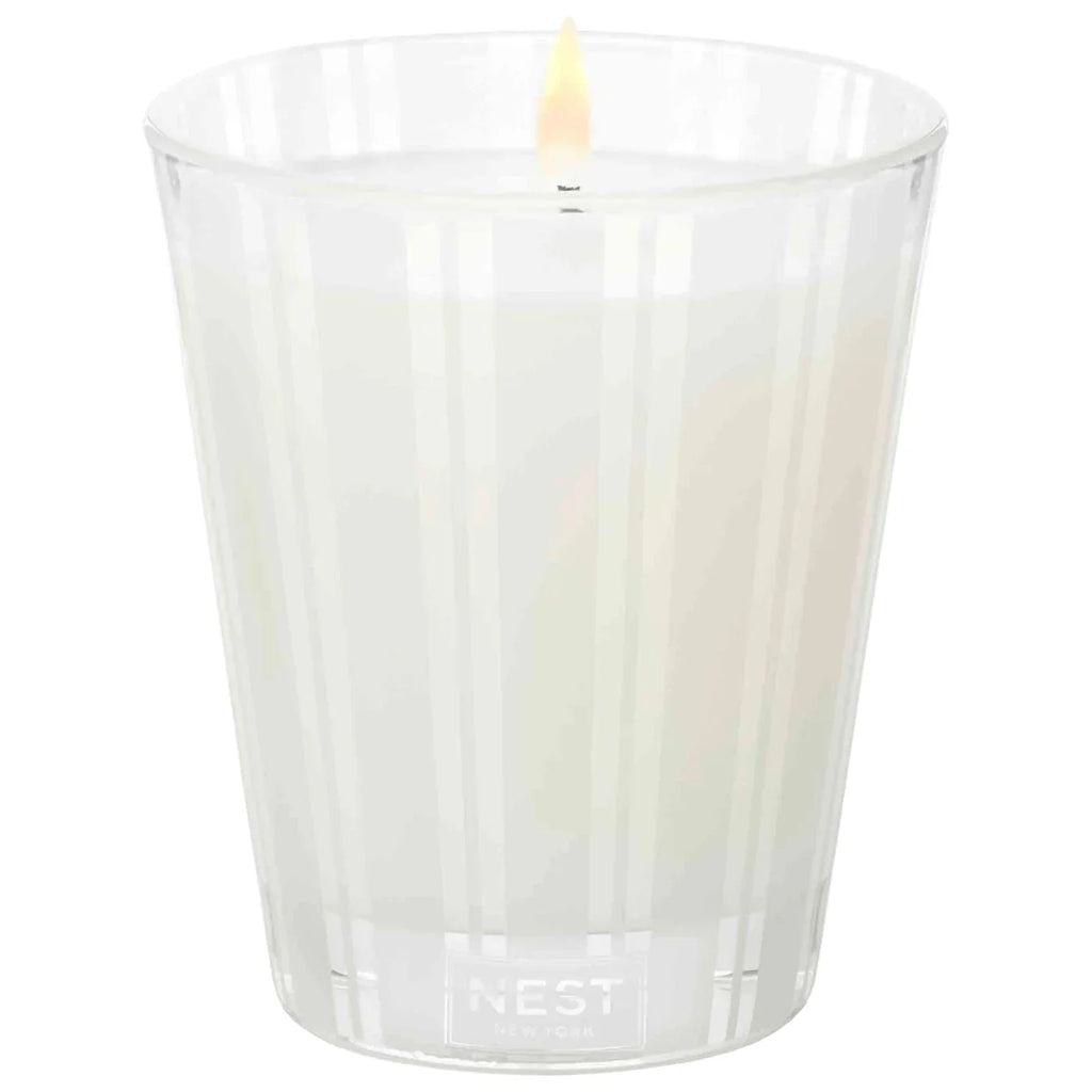 Grapefruit NEST candle in clear ridged glass tumbler with one flame and NEST logo