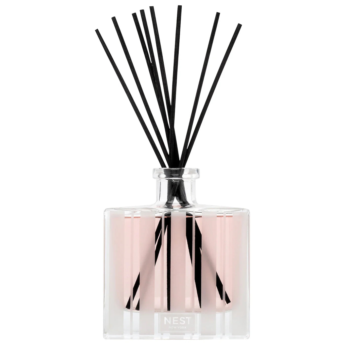Clear glass diffuser bottle with pink liquid, black reeds, silver top, NEST mark