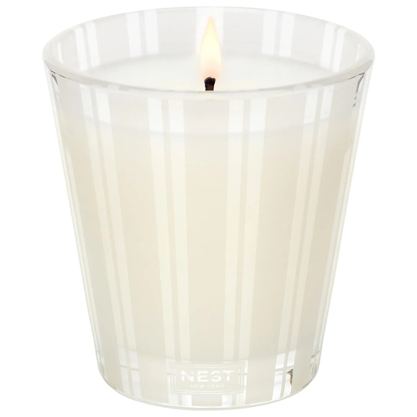 Scented candle in clear ribbed glass with lit wick, Madagascar Vanilla