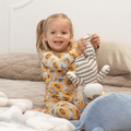 Kids pajama set with long-sleeve yellow sunflower print top and matching striped cuffs pants