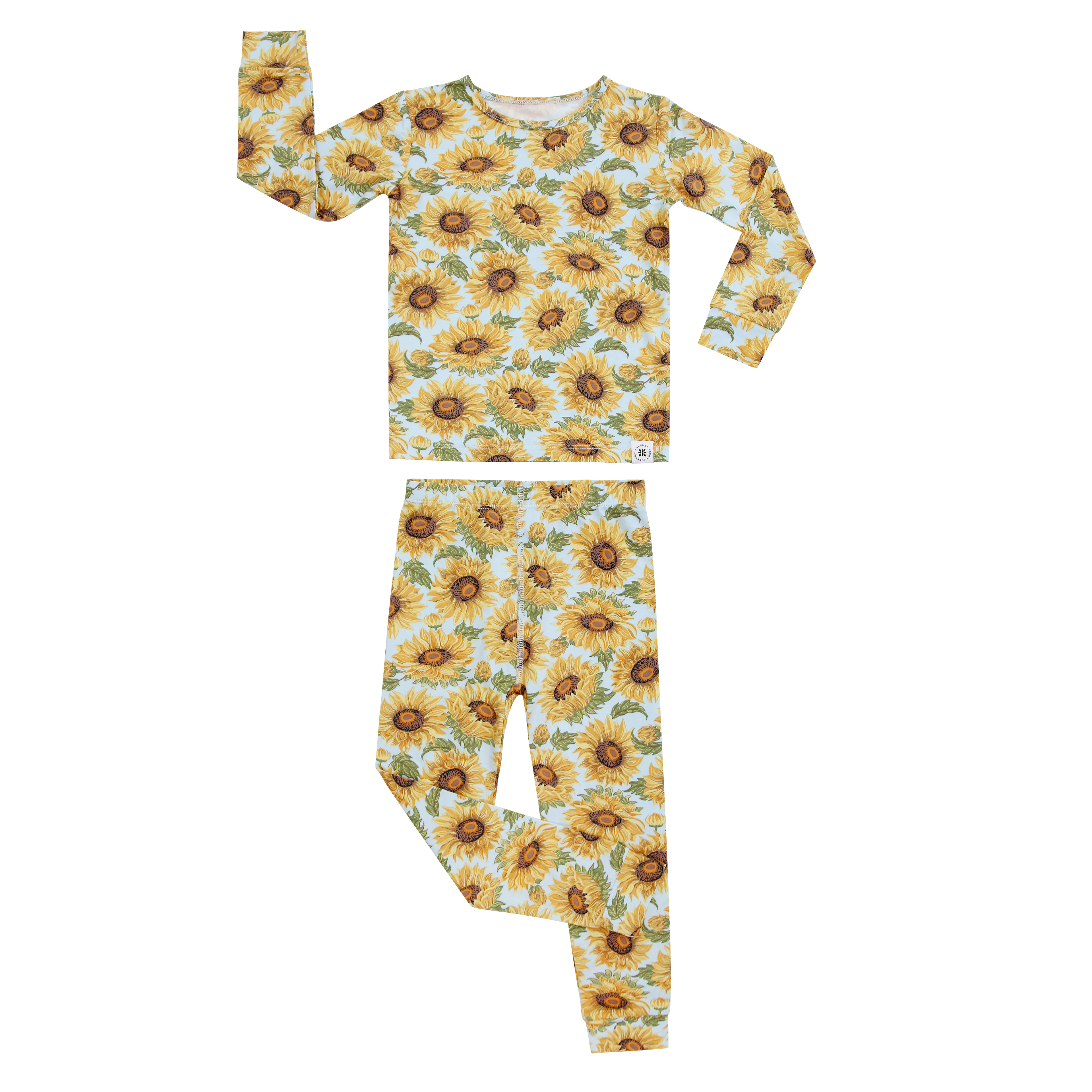Kids pajama set flat lay: yellow sunflower print long-sleeve shirt and matching pants