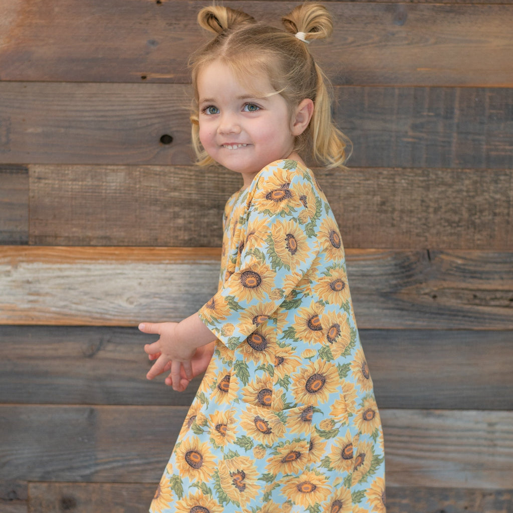 Sunflower print girl’s tunic with short sleeves and round neckline