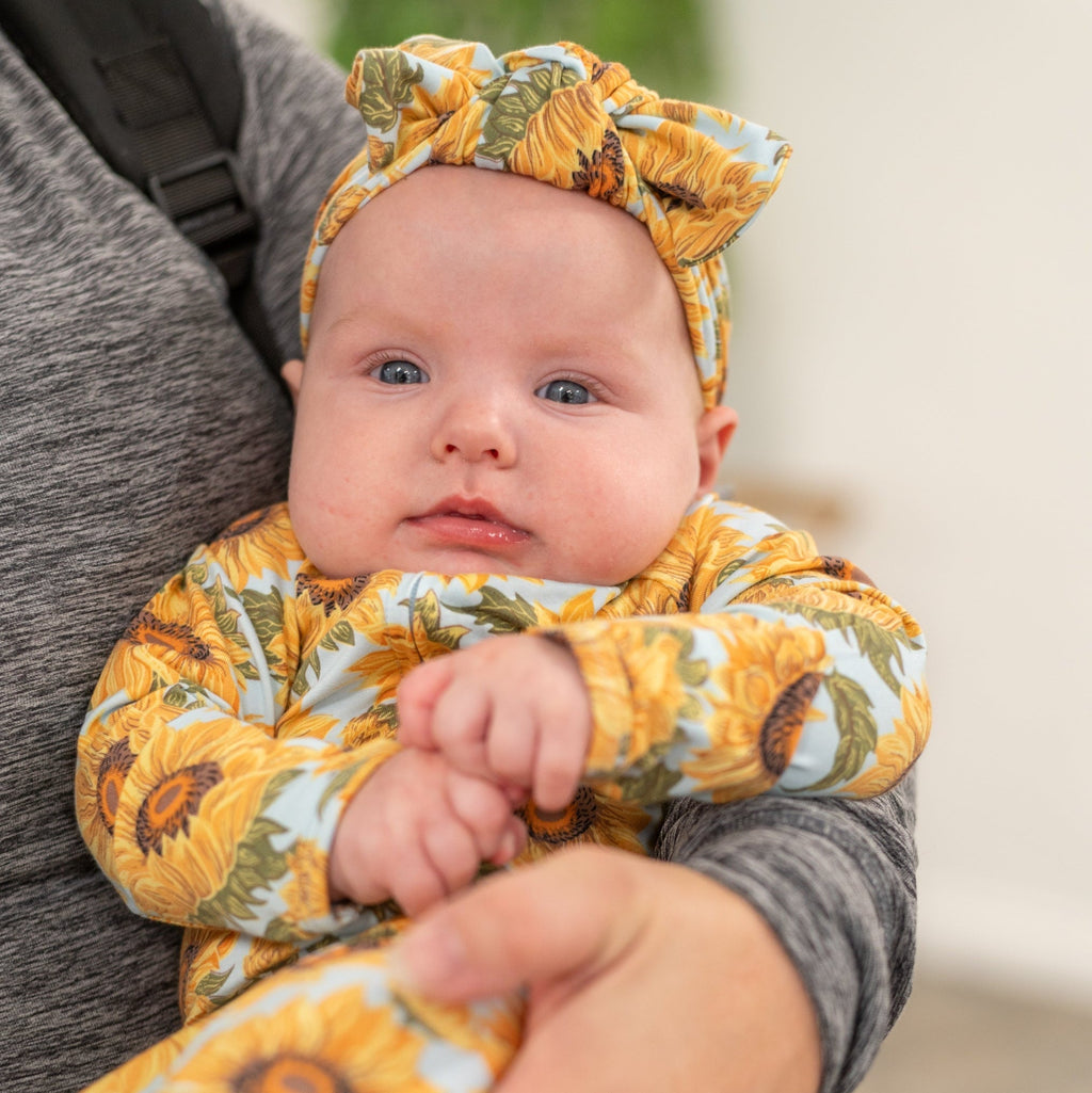 Sunflower zipper footie for baby with long sleeves, orange-yellow floral print