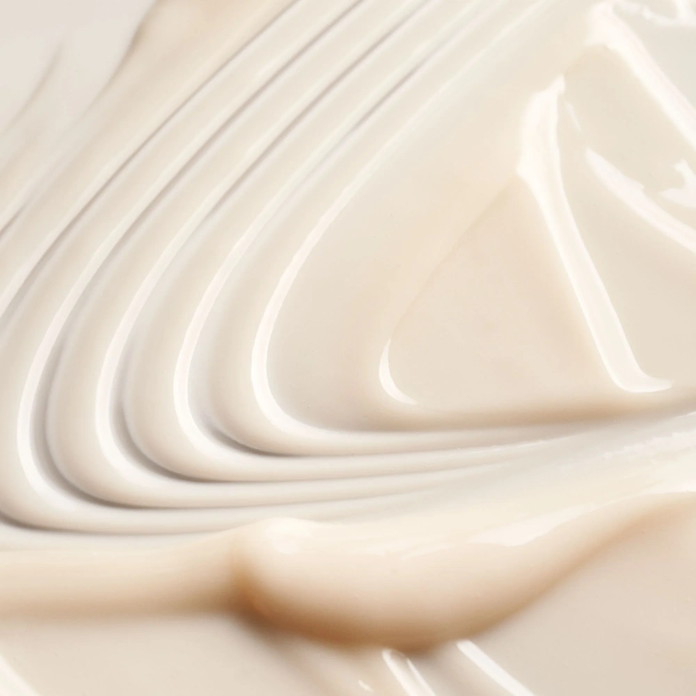 Thick white conditioner cream spread with smooth swirls