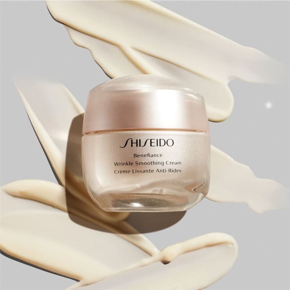 Shiseido Benefiance cream jar with beige cream swatches around