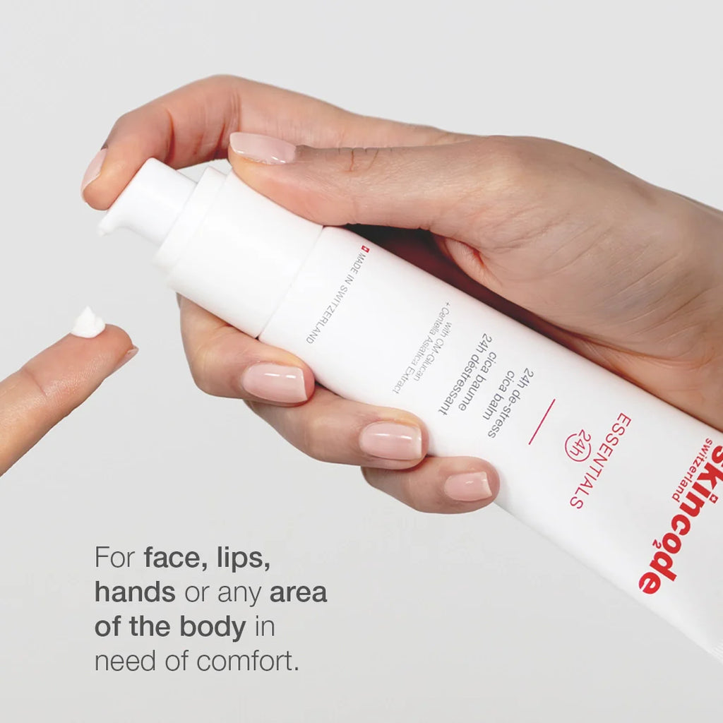 Cica balm tube held in hand with white cap and white cream on fingers