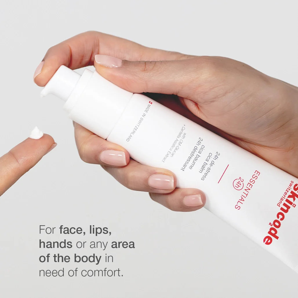 Cica balm tube held in hand with white cap and white cream on fingers