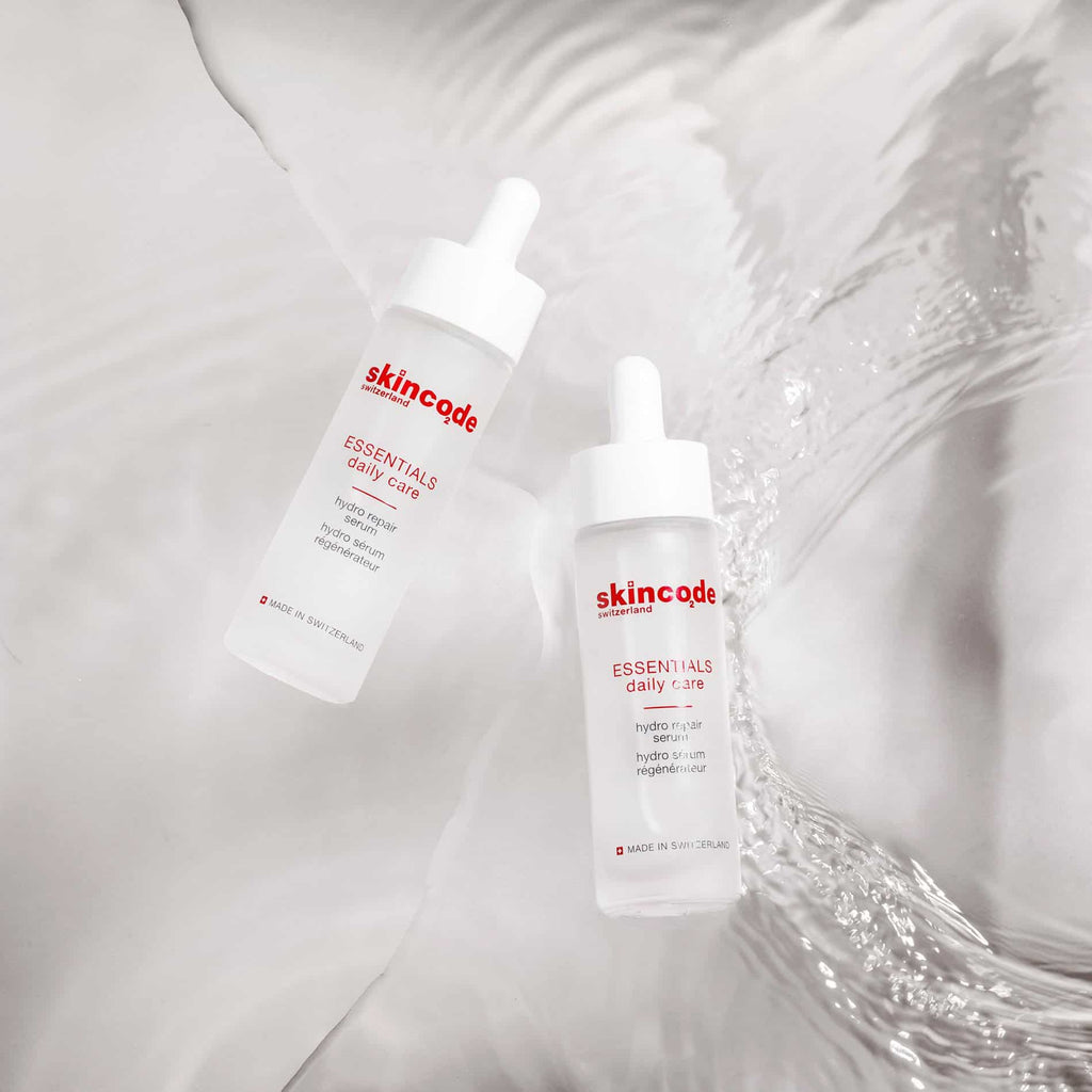 Skincode hydro repair serum bottles with droppers, white labels on two sizes