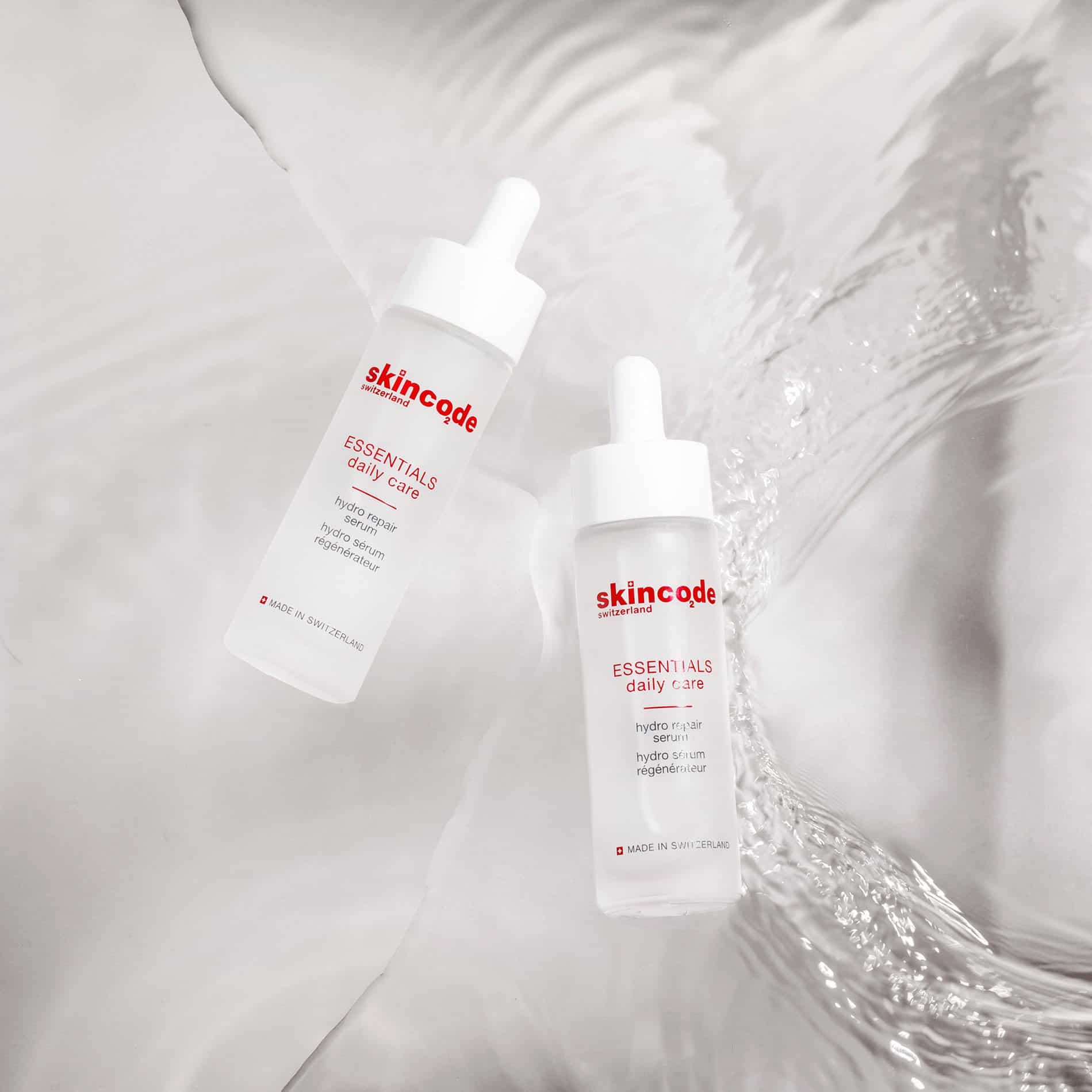 Skincode hydro repair serum bottles with droppers, white labels on two sizes
