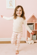 Girls classic leggings in light pink with white heart pattern, full-length
